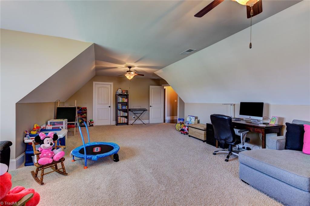 8889 Rymack Drive Oak Ridge, NC 27310 - Photo 25 of 30 Upper level bonus room. Walk in floored attic offers additional storage.