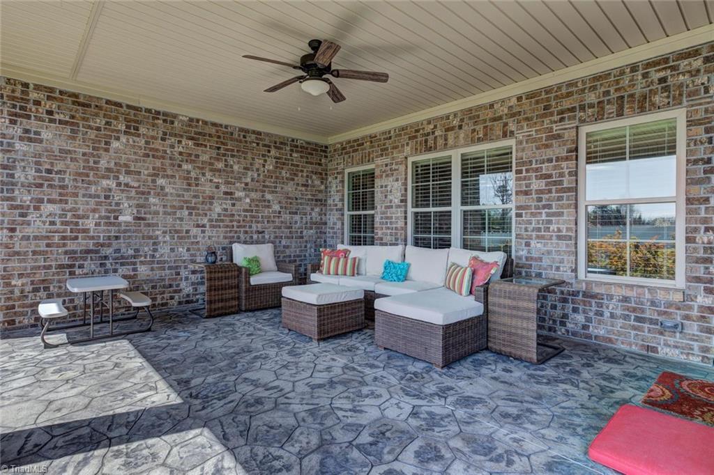 8889 Rymack Drive Oak Ridge, NC 27310 - Photo 26 of 30 Covered back porch offers plenty of outdoor entertaining and seating options.