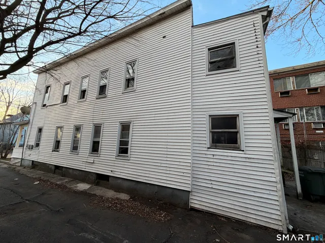 a view of a white house with many windows