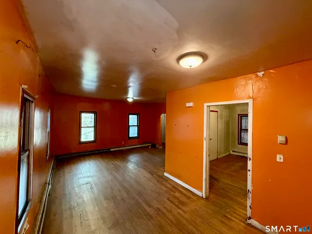 an empty room with windows and closet