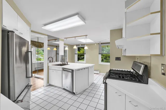 a kitchen with stainless steel appliances a stove a sink and a refrigerator