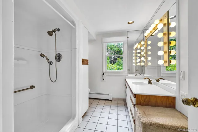 a bathroom with a tub shower and window