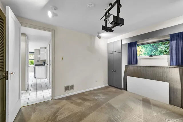 a view of a livingroom and a chandelier fan and windows