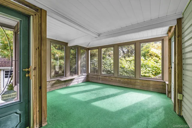 a living room with a large window and floor to ceiling window