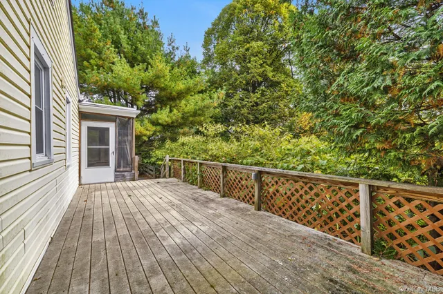 a view of balcony with wooden floor