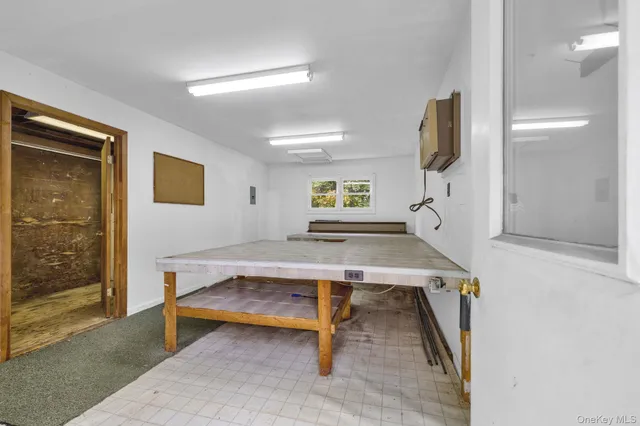 a living room with furniture pool table and a window
