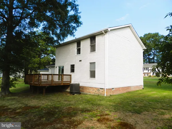a view of a white house with a yard