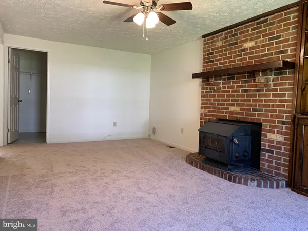 a view of empty room with a fireplace