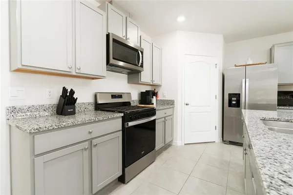 a living room with furniture a flat screen tv and a window