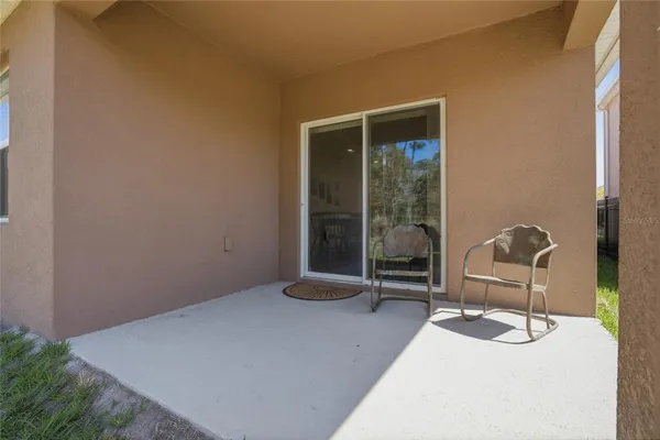 a view of a dining room with furniture and a chandelier