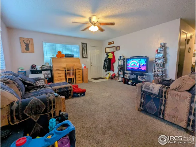 a bedroom with furniture and a flat screen tv