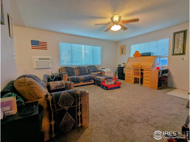 a view of a livingroom with furniture and a ceiling fan