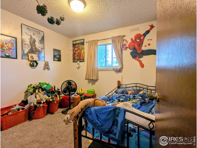 a room with furniture and paintings on the wall