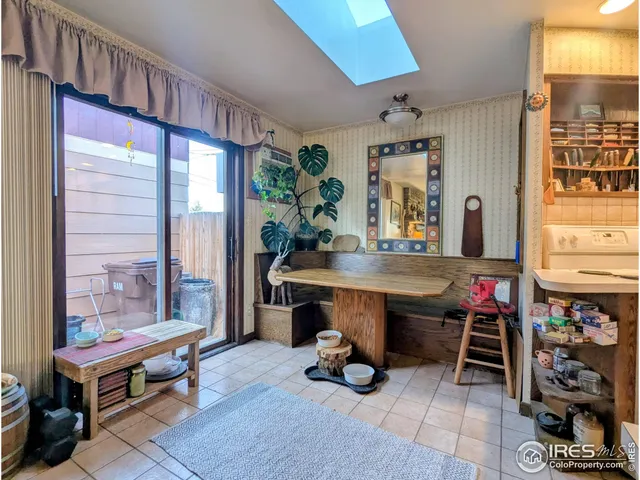 a room with lots of furniture and a window