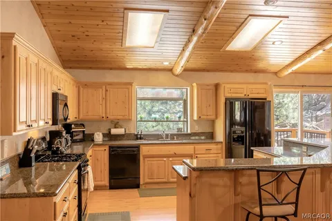 a kitchen with granite countertop a sink and a stove