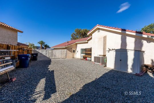1217 Flora Way Ridgecrest, CA 93555 - Photo 39 of 39 a view of a house with backyard and trees
