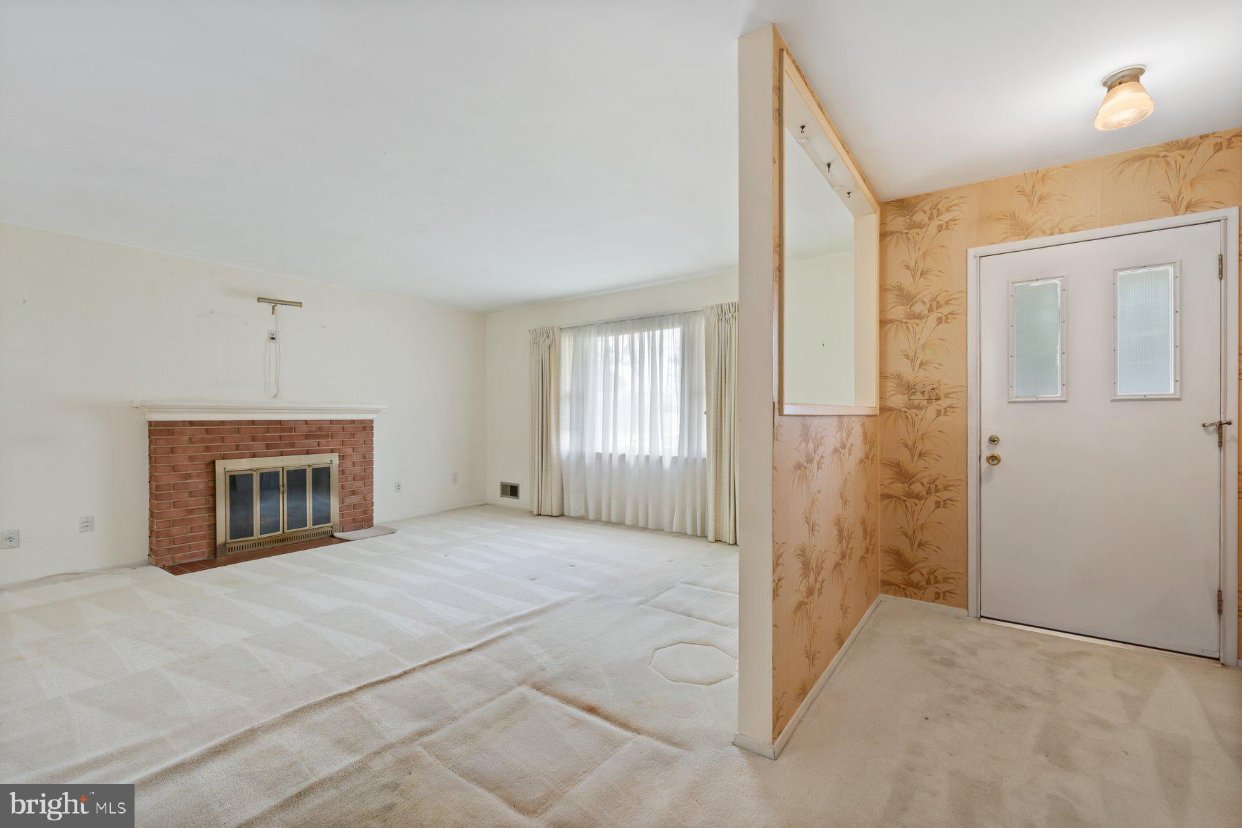 5304 Moultrie Road Springfield, VA 22151 - Photo 14 of 38 a view of an empty room with a fireplace and a window