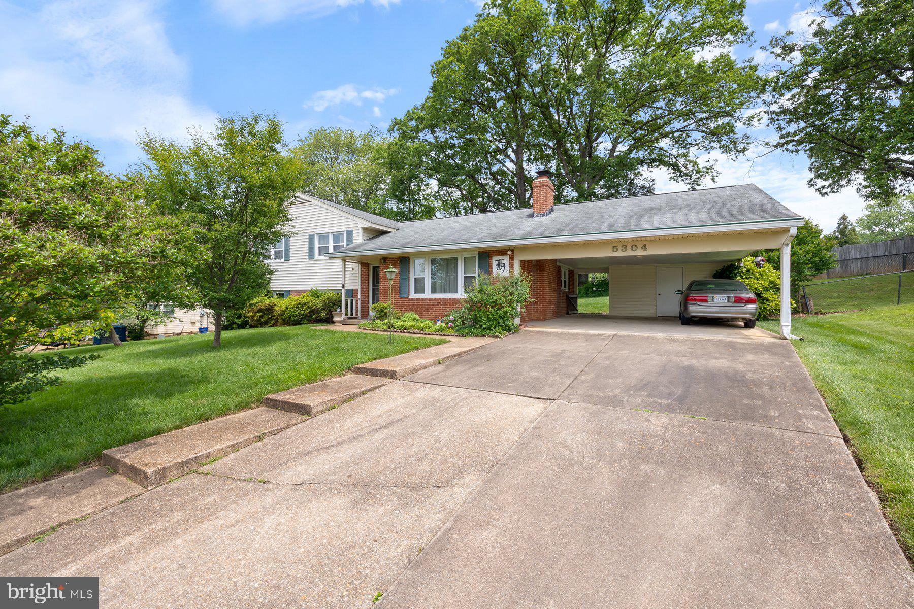 5304 Moultrie Road Springfield, VA 22151 - Photo 2 of 38 a view of house with a yard and potted plants