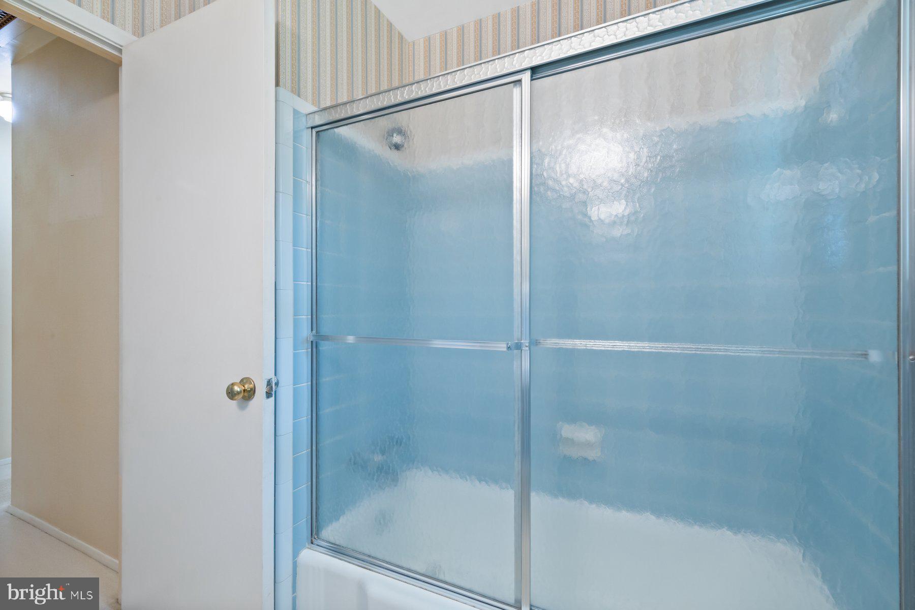 5304 Moultrie Road Springfield, VA 22151 - Photo 23 of 38 a bathroom with a glass shower door