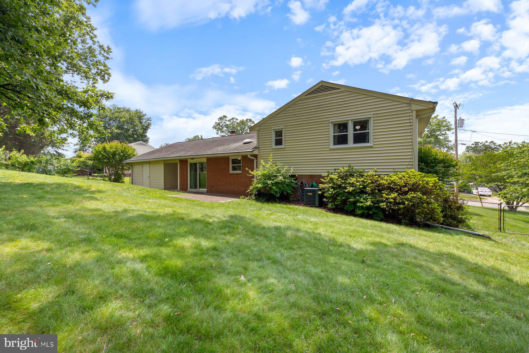5304 Moultrie Road Springfield, VA 22151 - Photo 34 of 38 a yellow and red house with a garden