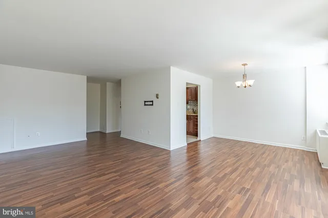 a view of an empty room and wooden floor