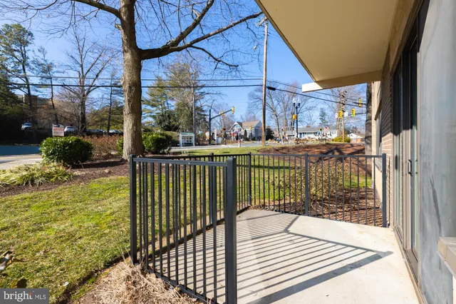 a view of a balcony with a floor to ceiling window next to a yard