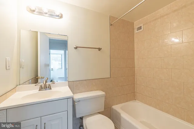 a bathroom with a sink toilet a mirror and shower