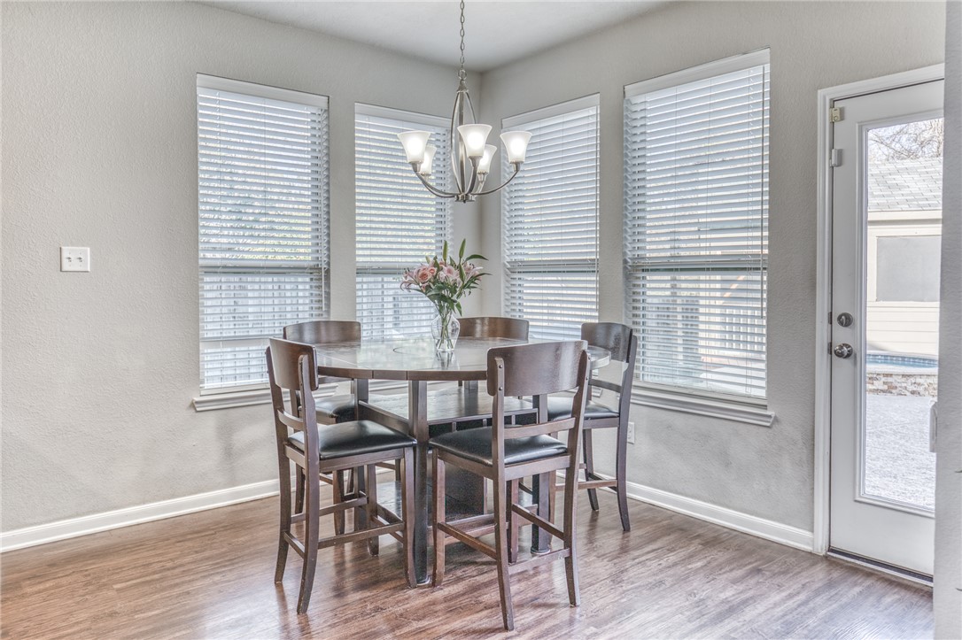 1827 Basin Trail Brenham, TX 77833 - Photo 11 of 38 a view of a dining room with furniture wooden floor and chandelier