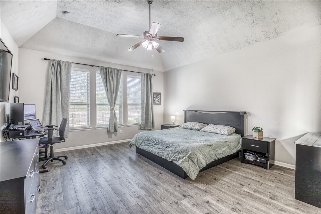 1827 Basin Trail Brenham, TX 77833 - Photo 13 of 38 a spacious bedroom with a bed and a large window