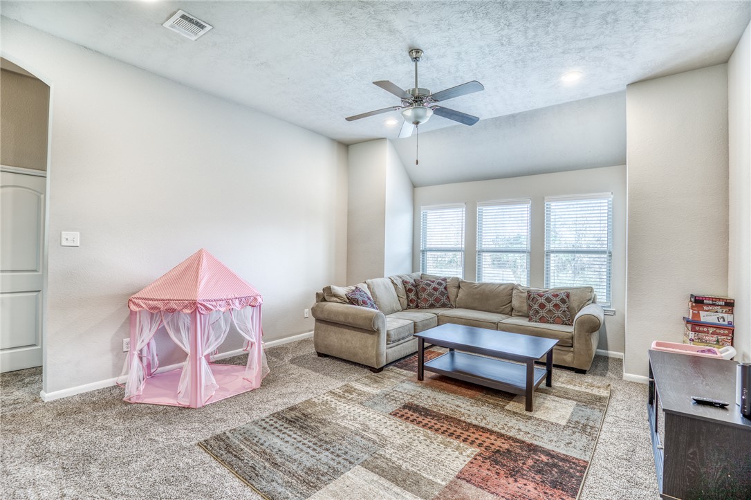 1827 Basin Trail Brenham, TX 77833 - Photo 17 of 38 a living room with furniture and a window