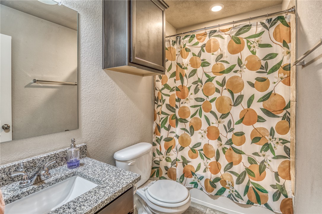 1827 Basin Trail Brenham, TX 77833 - Photo 19 of 38 a bathroom with a granite countertop sink toilet and shower