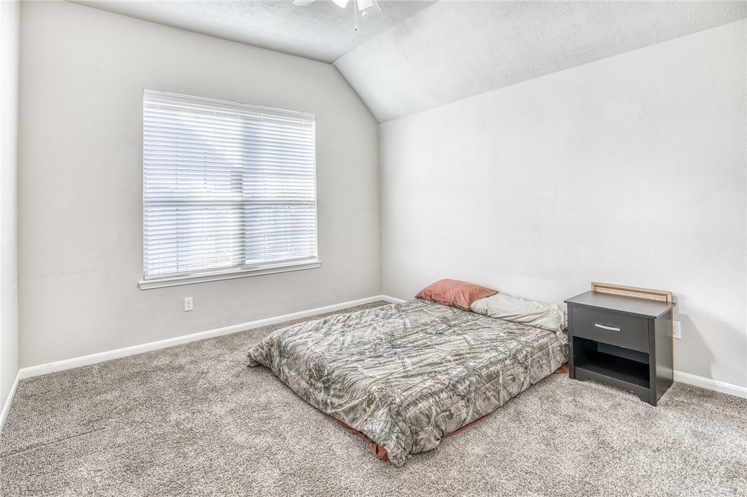 1827 Basin Trail Brenham, TX 77833 - Photo 22 of 38 a bedroom with a bed and a window