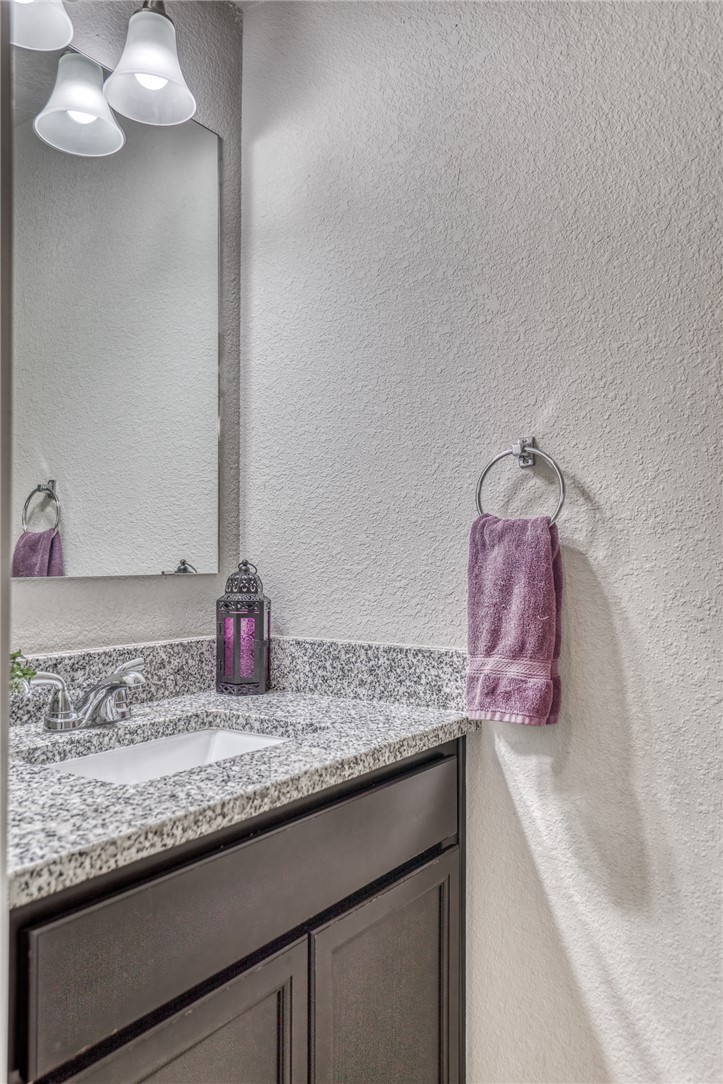 1827 Basin Trail Brenham, TX 77833 - Photo 23 of 38 a bathroom with a granite countertop sink and a mirror