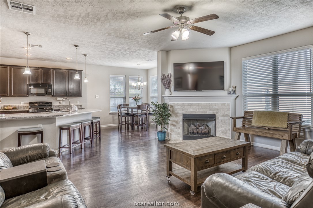 1827 Basin Trail Brenham, TX 77833 - Photo 5 of 38 a living room with furniture and a flat screen tv