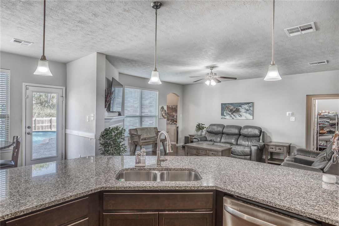 1827 Basin Trail Brenham, TX 77833 - Photo 9 of 38 a kitchen with a counter space cabinets and stainless steel appliances