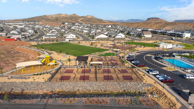 2133 Wolverine Way, Unit 2440 Washington, UT 84780 - Photo 37 of 39 Community recreation area featuring multiple pickleball courts, a playground with shade structures, and an expansive aquatic facility with a swimming pool