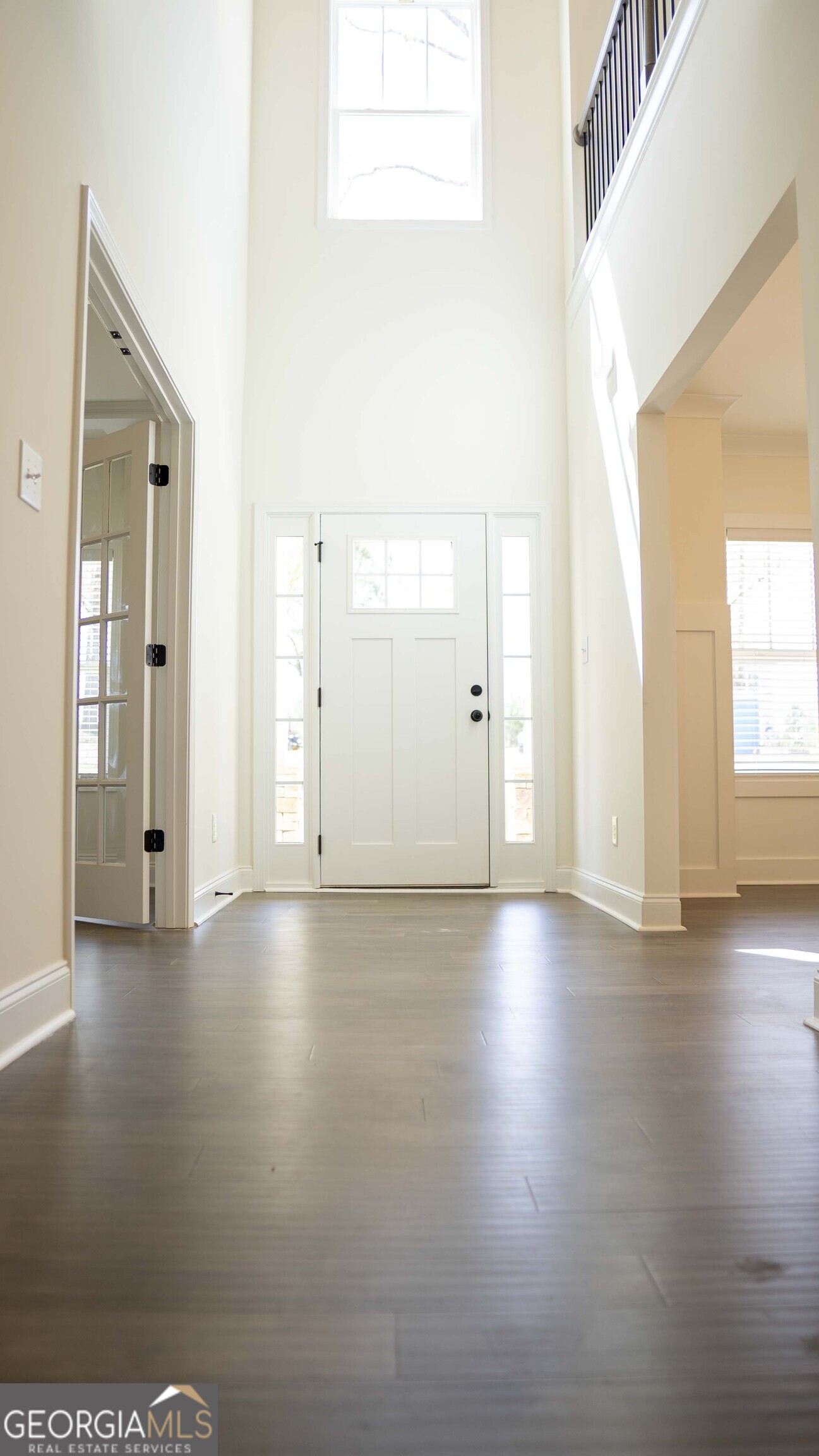 604 Beaver Court Perry, GA 31069 - Photo 5 of 40 an empty room with window and wooden floor