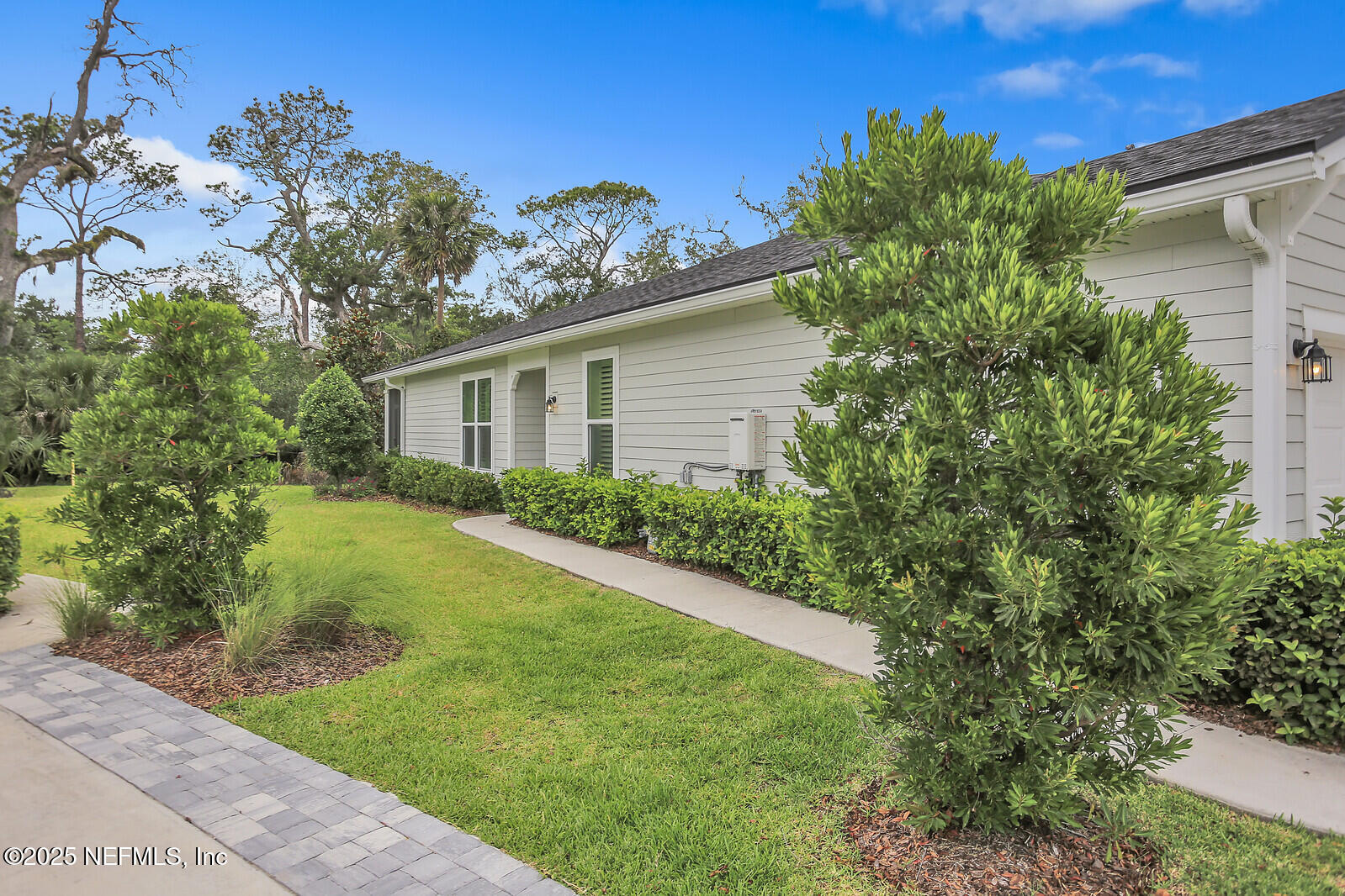 133 Leeward Island Drive St. Augustine, FL 32080 - Photo 2 of 48 a front view of a house with garden