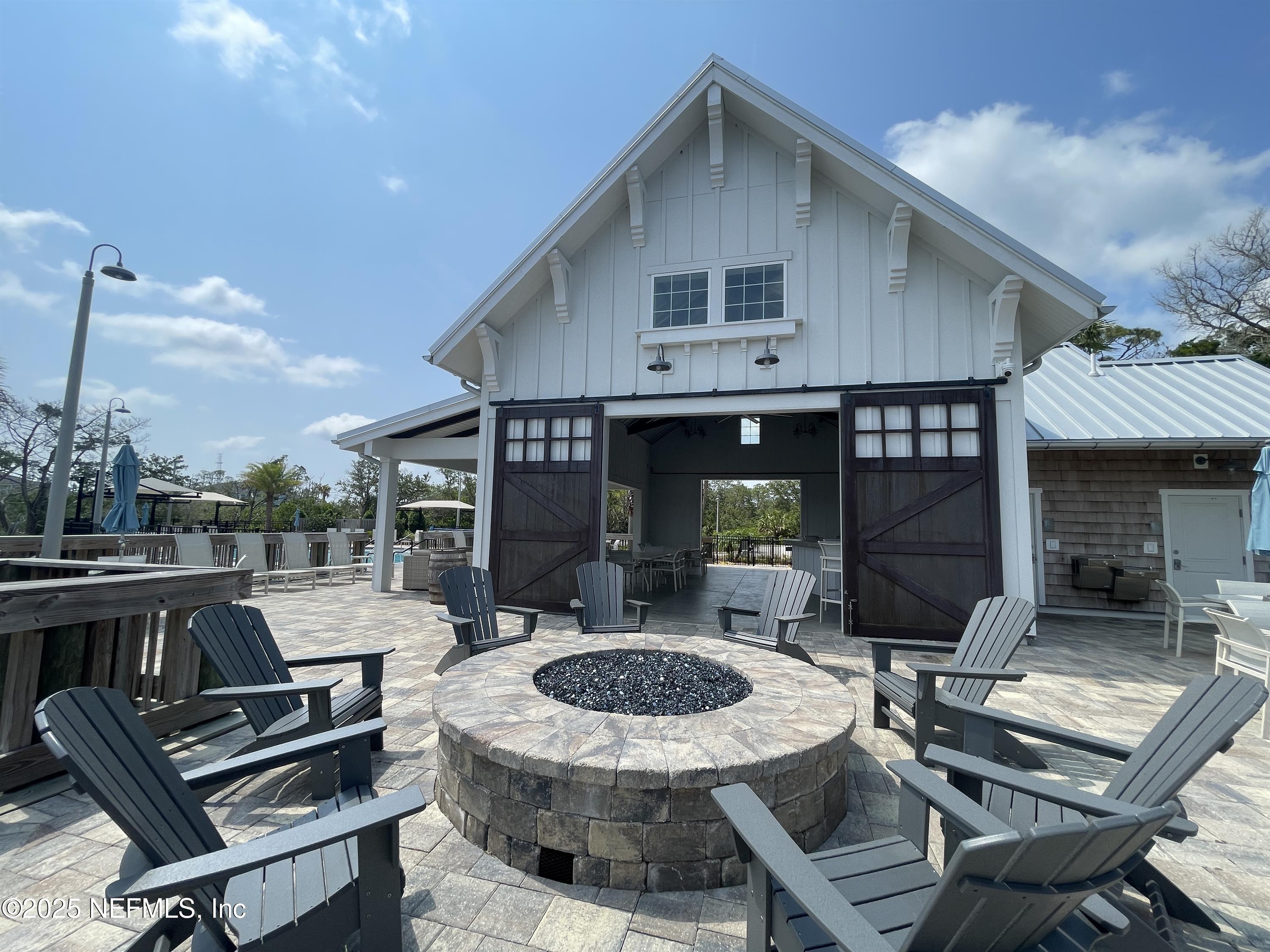 133 Leeward Island Drive St. Augustine, FL 32080 - Photo 47 of 48 a view of a patio with table and chairs with wooden floor and fence