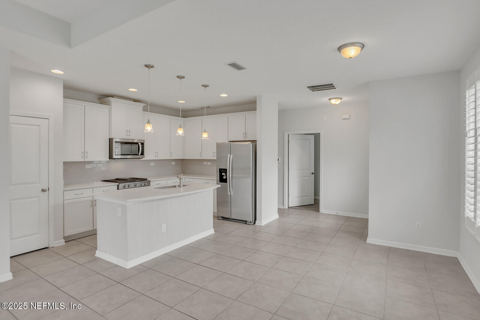 133 Leeward Island Drive St. Augustine, FL 32080 - Photo 6 of 48 a kitchen with stainless steel appliances granite countertop a refrigerator and a stove top oven
