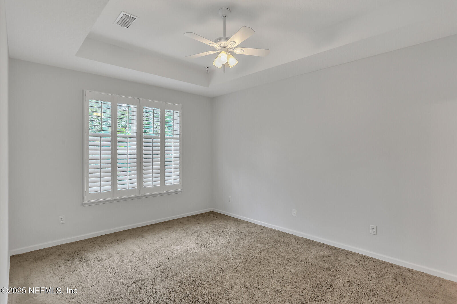 133 Leeward Island Drive St. Augustine, FL 32080 - Photo 10 of 48 an empty room with windows and chandelier fan