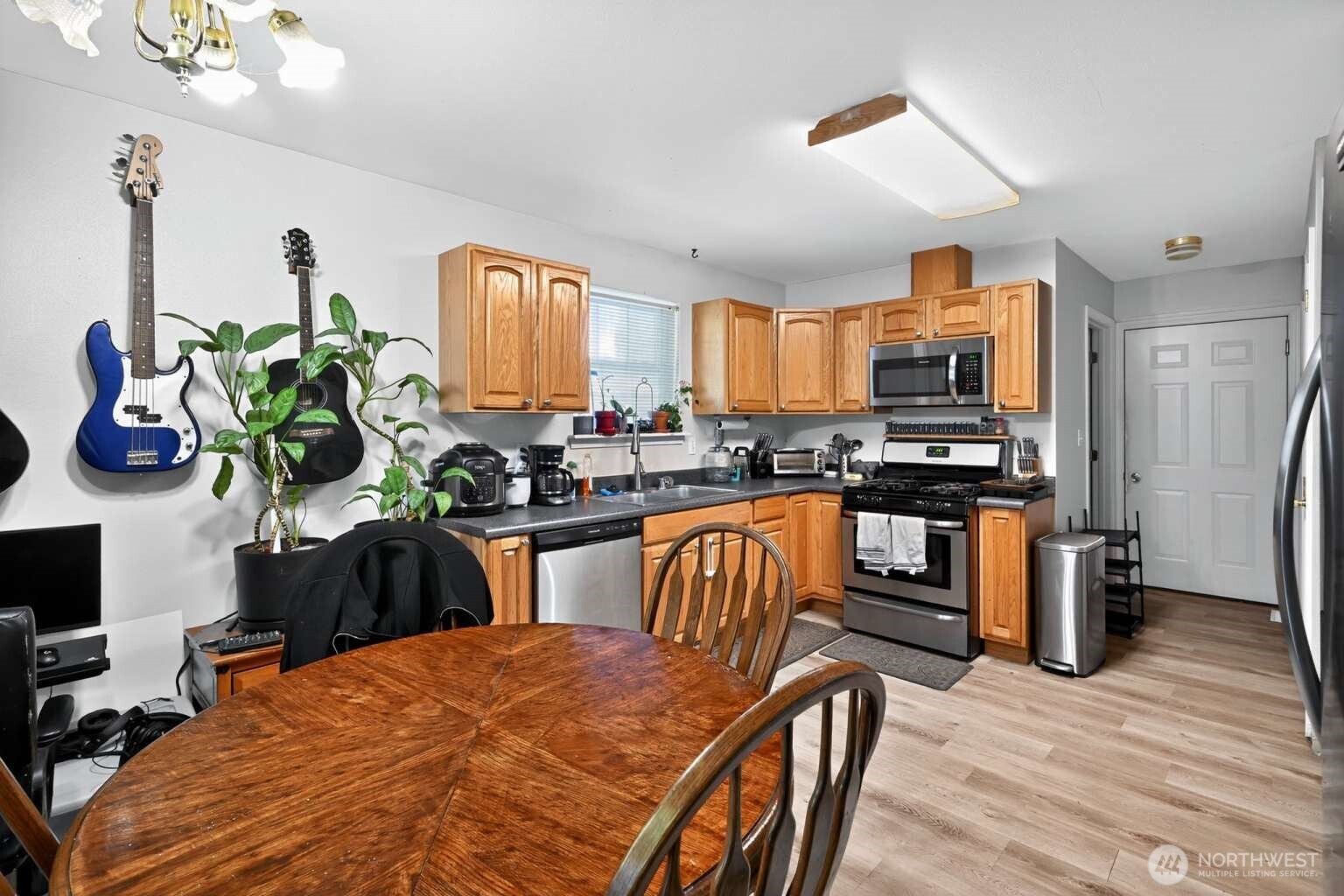 2972 Brook Lane Sedro-Woolley, WA 98284 - Photo 13 of 35 a kitchen with stainless steel appliances kitchen island granite countertop a refrigerator a stove a sink a stove a dining table and chairs with wooden floor