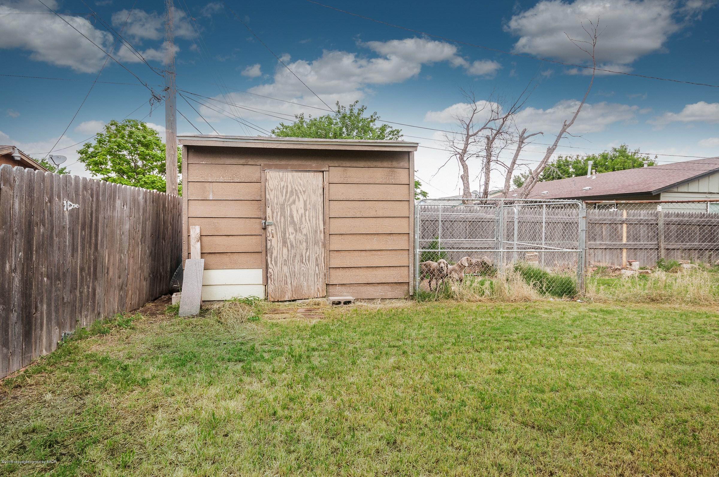 5312 Parker Street Amarillo, TX 79110 - Photo 12 of 13 a view of a backyard with small plants and wooden fence