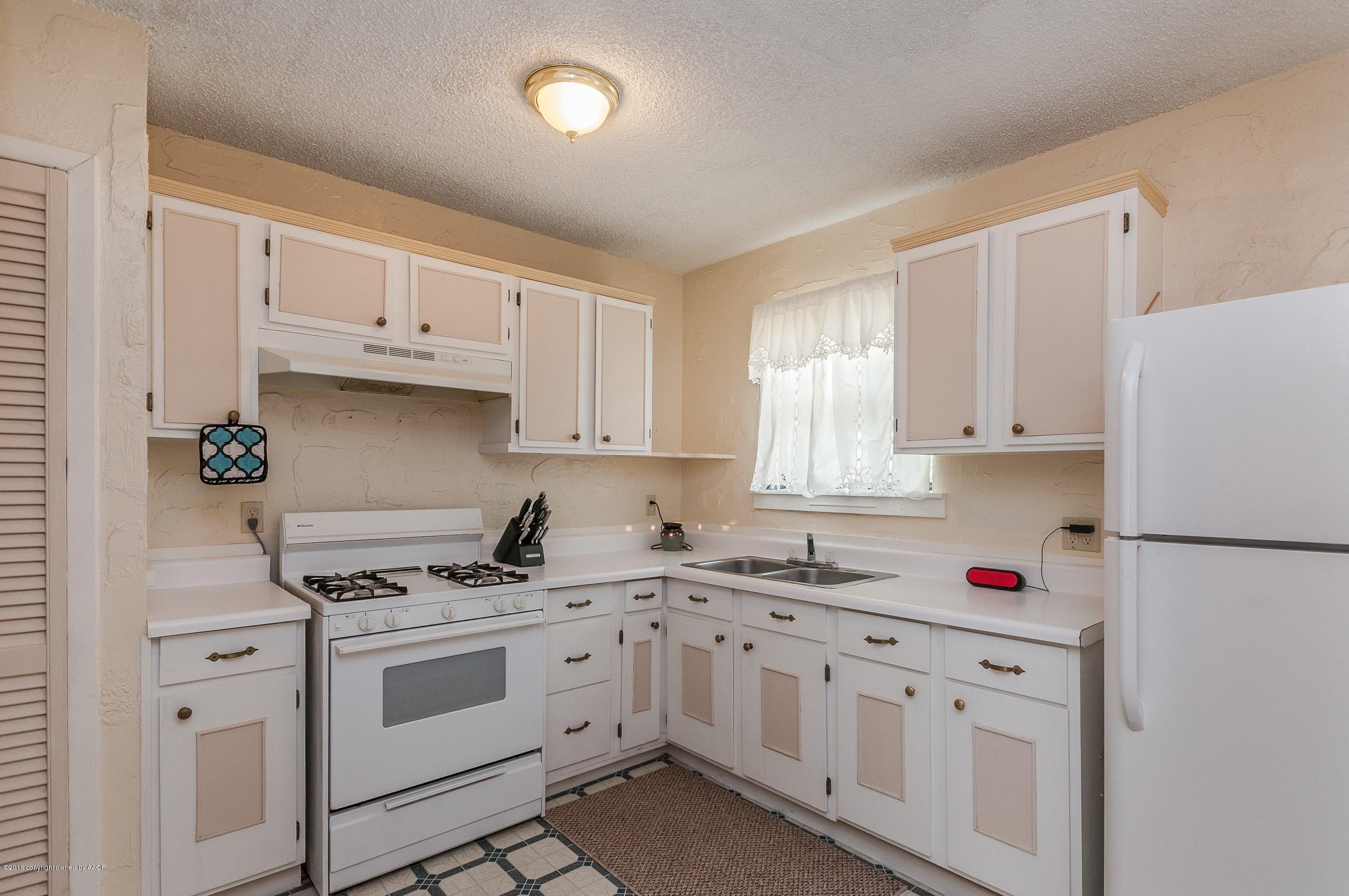 5312 Parker Street Amarillo, TX 79110 - Photo 3 of 13 a white kitchen with sink and white appliances