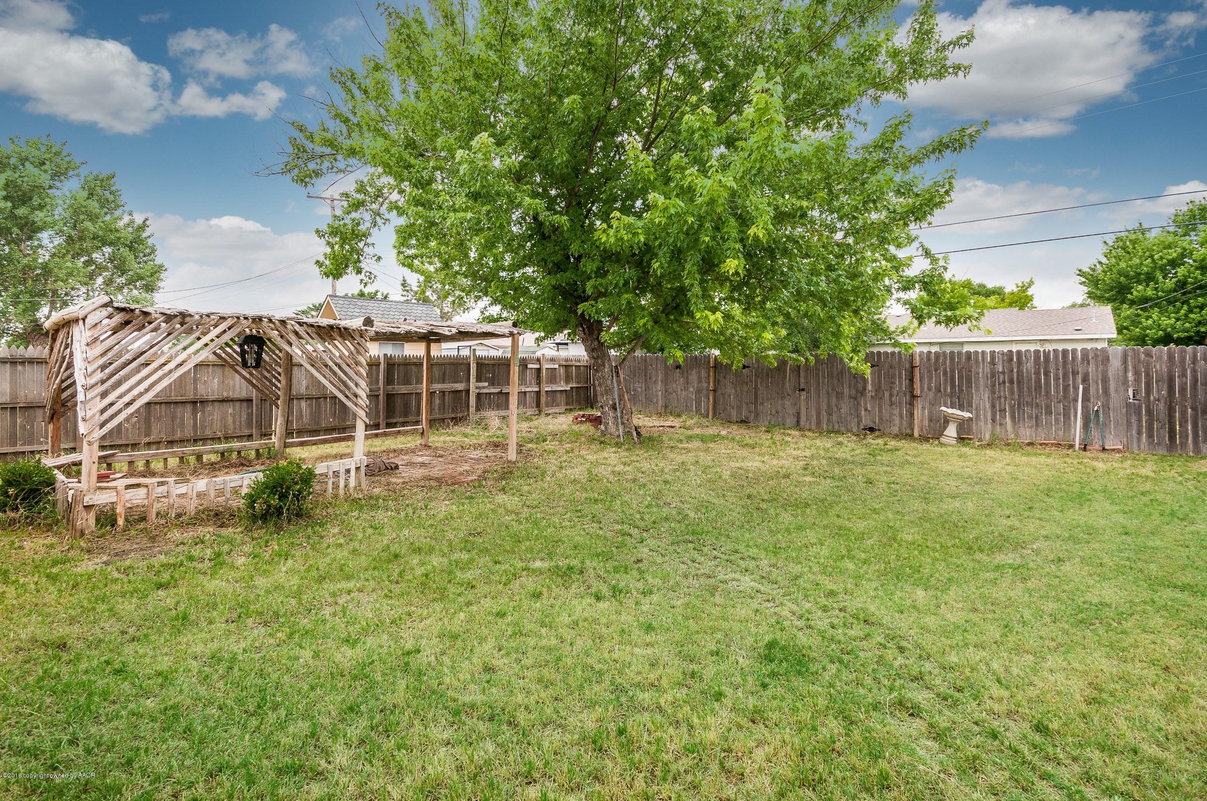 5312 Parker Street Amarillo, TX 79110 - Photo 5 of 13 a house with trees in the background