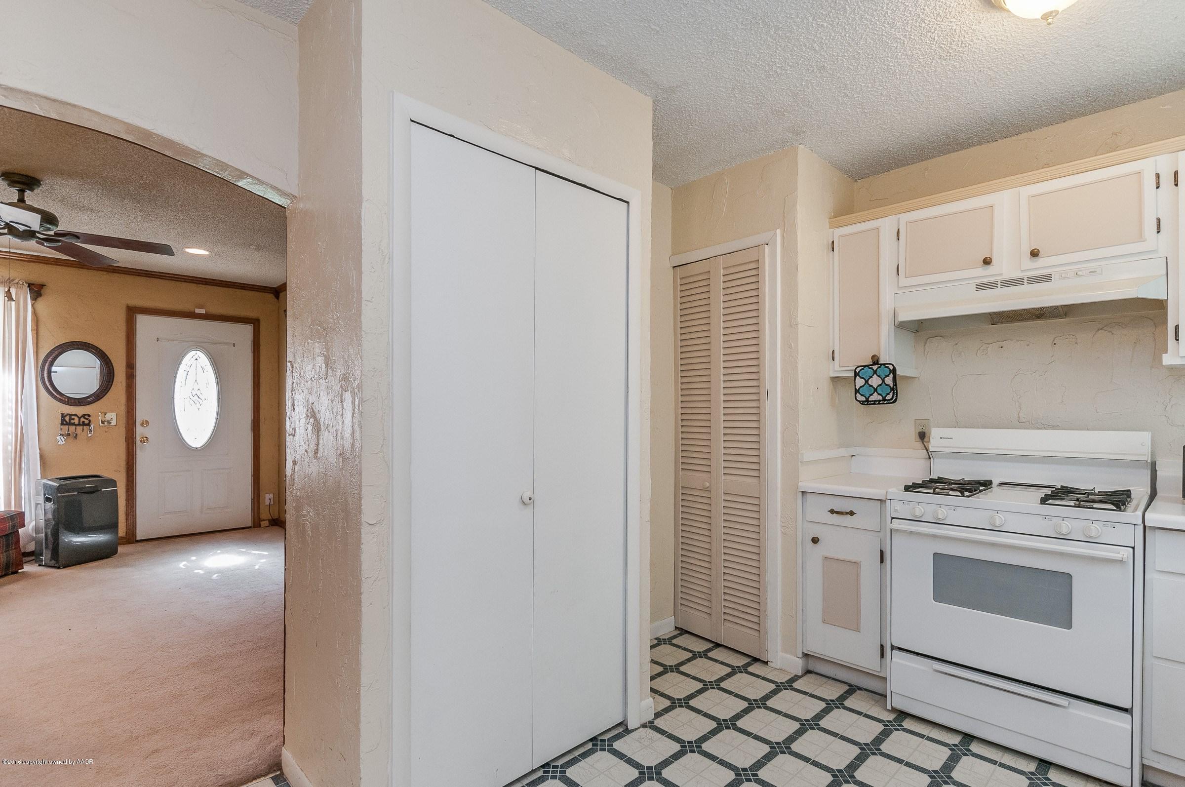 5312 Parker Street Amarillo, TX 79110 - Photo 7 of 13 a kitchen with stainless steel appliances a stove a microwave and cabinets