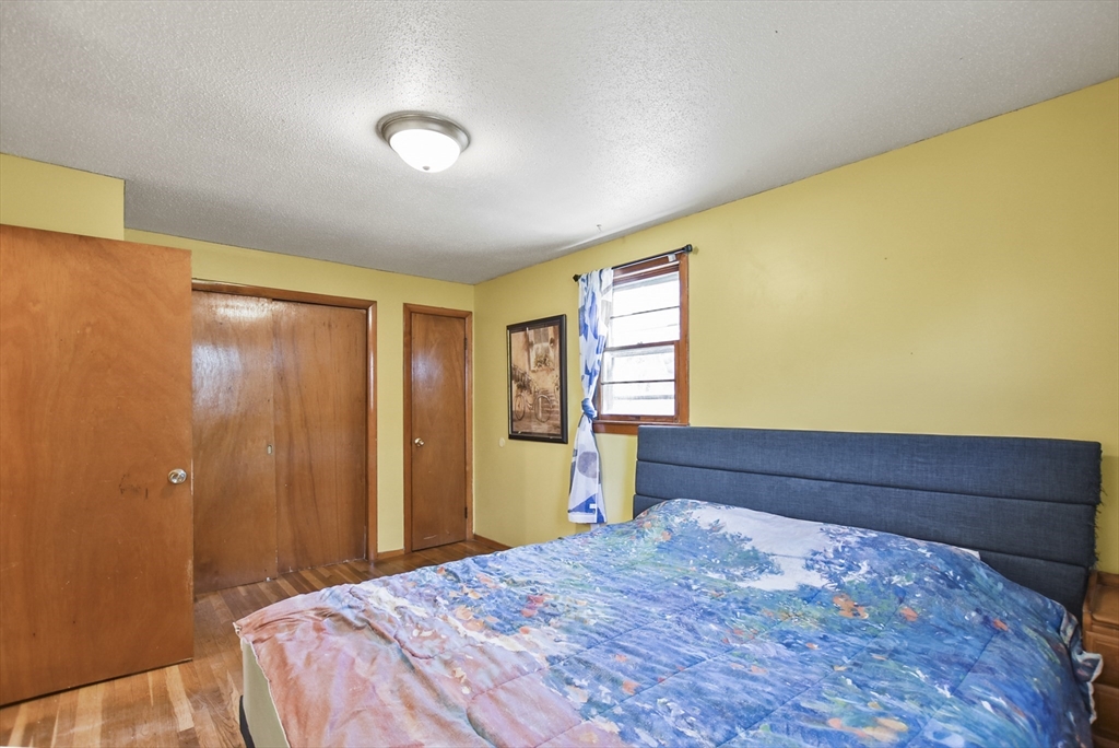 23 Harold Street Worcester, MA 01604 - Photo 23 of 32 a bed room with a bed and a dresser