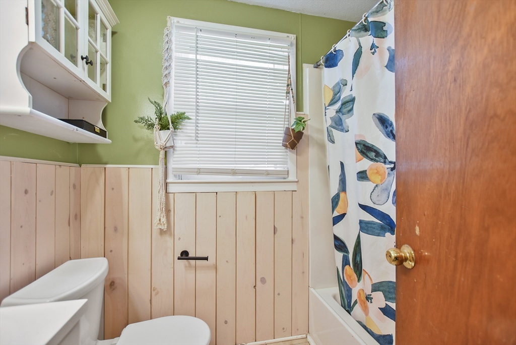 23 Harold Street Worcester, MA 01604 - Photo 25 of 32 a bathroom with a toilet and shower curtain