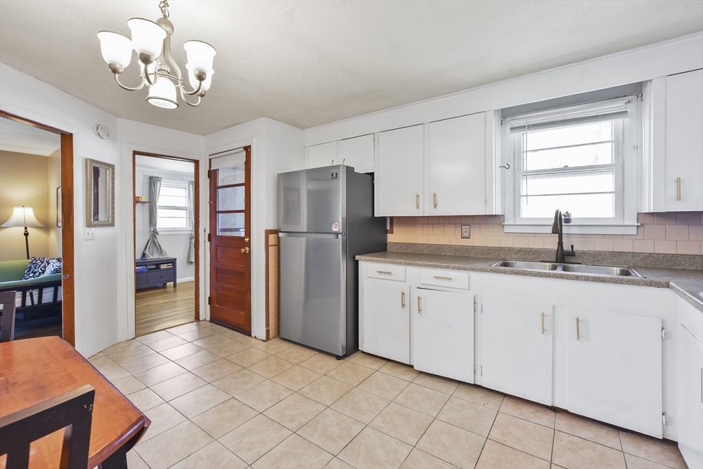 23 Harold Street Worcester, MA 01604 - Photo 6 of 32 a kitchen with granite countertop a refrigerator and a sink