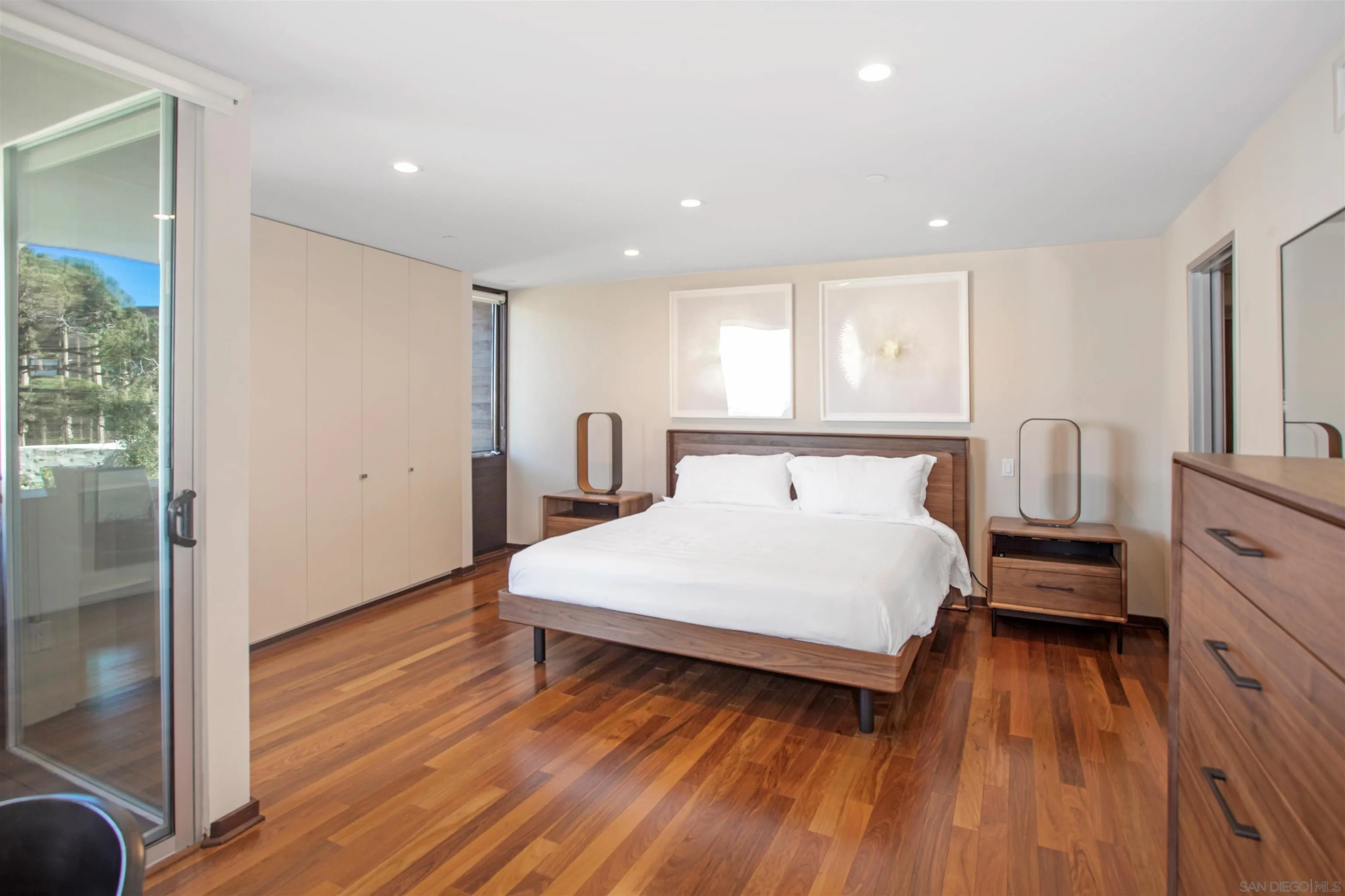 427 Ravina Street La Jolla, CA 92037 - Photo 13 of 36 a spacious bedroom with a bed and wooden floor